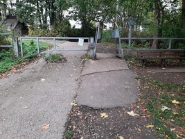 Entrance to transpennine trail. A metal gate across the path with a narrow gap beside it.
