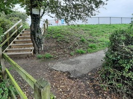 Steps up to the reservoir from the Mill pond, with a wheelchair accessible route leading to the right